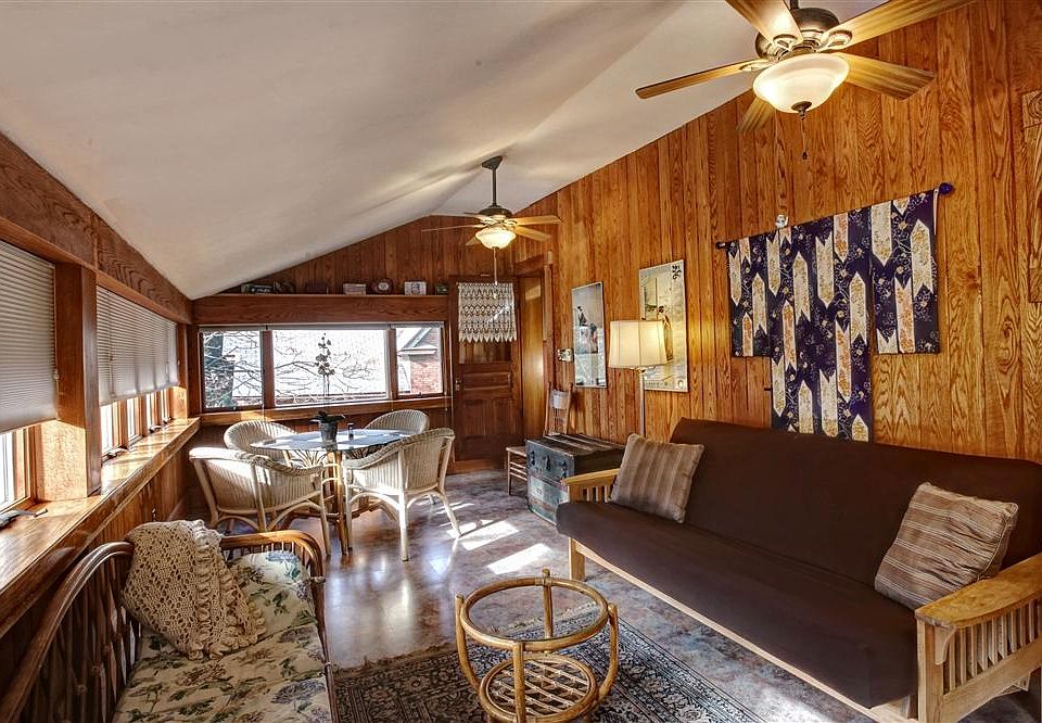 View of the sun-room with futon and dining table.