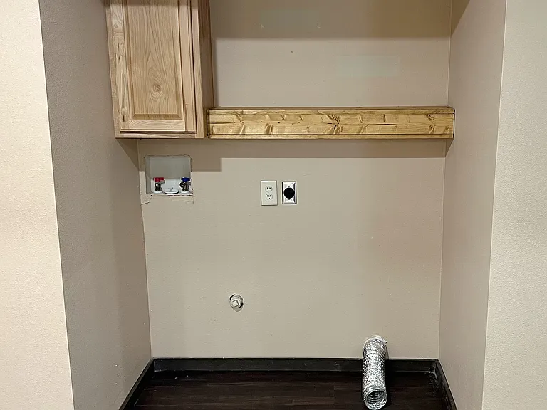Cute washer and dryer nook with storage
