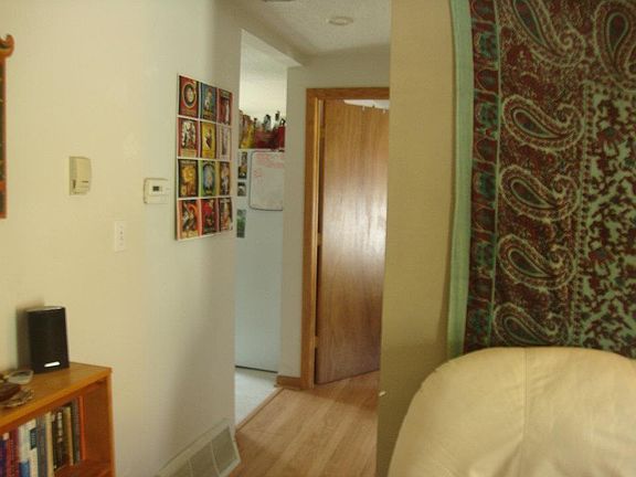 Part of living area with hallway to kitchen area.