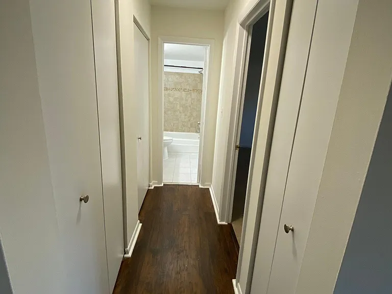 Hallway with three closets