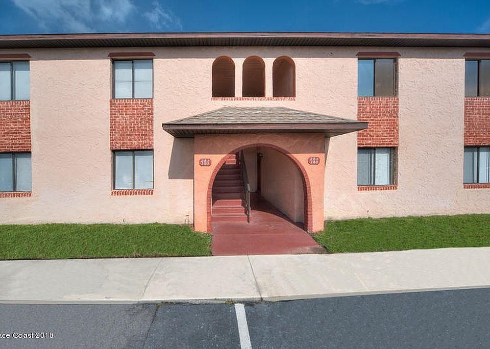 Front with reserved parking space in front of the door.