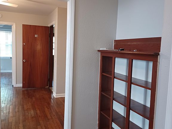 Inside entry. Built-in shelves in dining room.