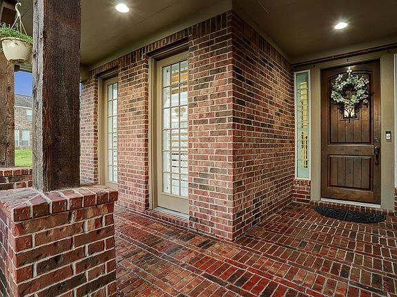 Enjoy your quiet, friendly neighborhood on this inviting bricked front porch with plenty of room to sit. Will be a great place to show off your holiday decorations.