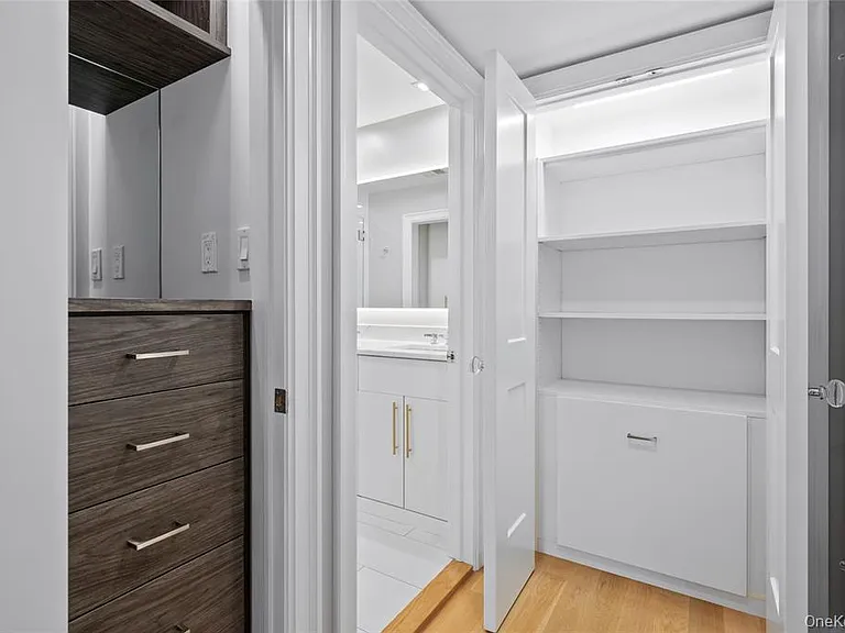 2 more closets with custom shelving and cabinetry in primary bedroom