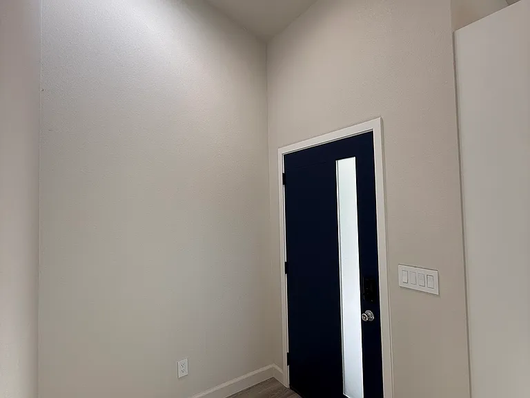Entry hall with high ceilings and natural light.