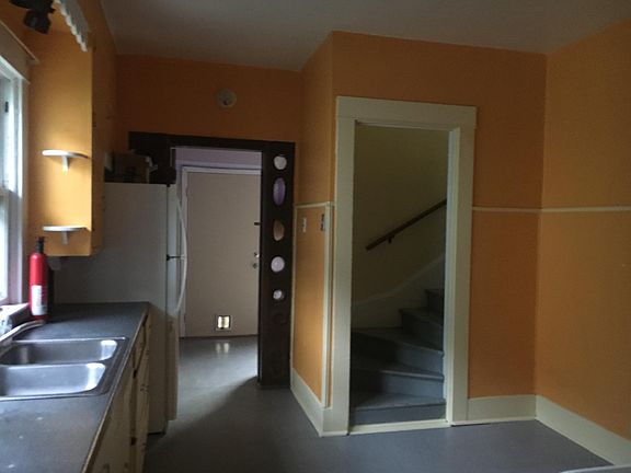 Kitchen leads to back room and upstairs