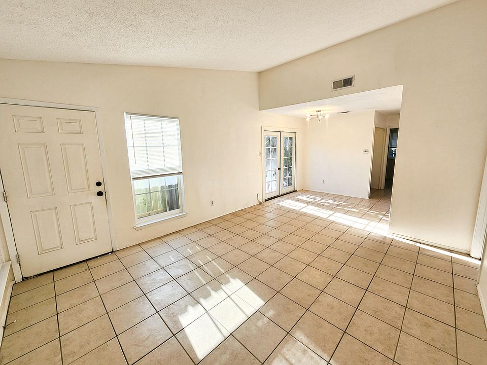 Living room/den area with high ceiling and plenty of natural light