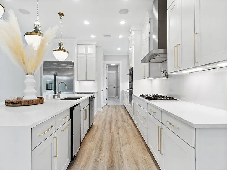 Kitchen flows into full bar, then laundry, and dog washing station.