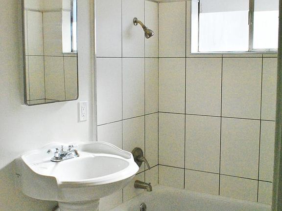 Updated bathrooms have vintage pedestal sinks, newly retiled