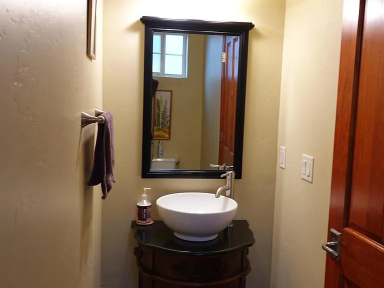 Downstairs half-bath next to dining space.