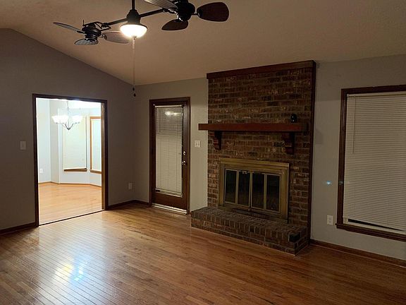 Large Family room with vaulted ceilings, double fans and wood burning fireplace