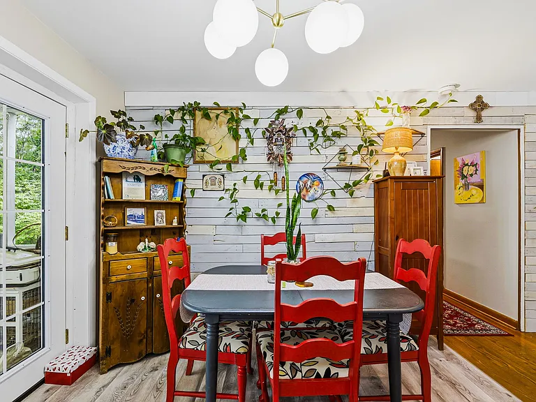MAIN LEVEL: Dining Area, Double Opening French Doors (on left) and Hall (ahead on right) (Living Room to Right, Kitchen behind camera)