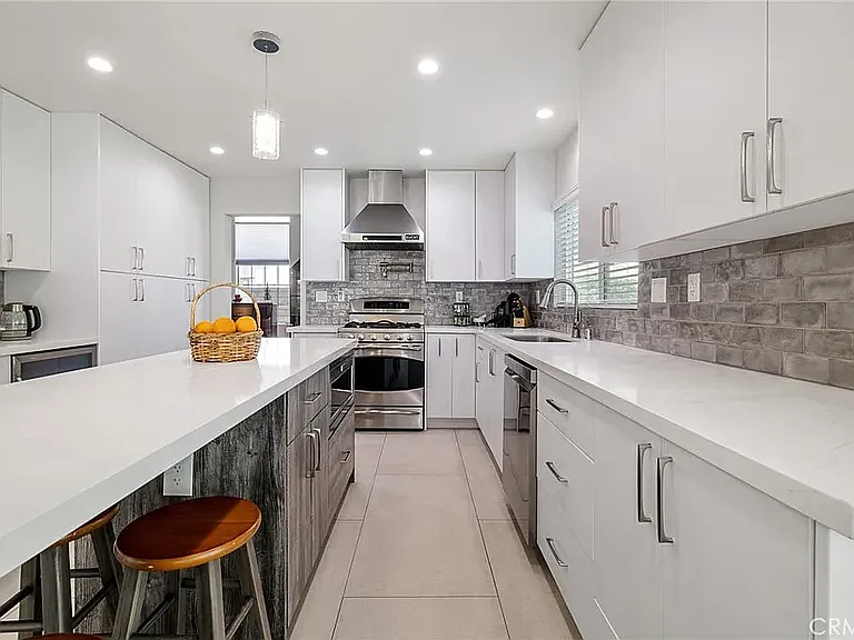 Bright, functional kitchen with shared access, plenty of workspace, and convenient amenities for daily cooking needs.