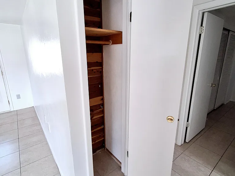 Hall closet leading to the bedrooms/bathroom.