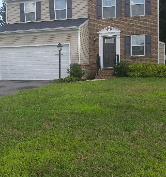 Front Exterior. Part brick front part vinyl. 2 car garage