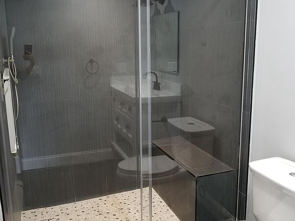 Spacious shower with glass sliding door