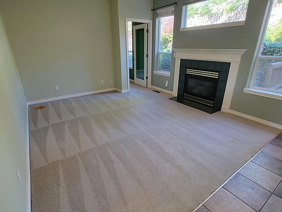 Living room features gas fireplace and lots of natural light