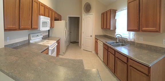 Kitchen with large pantry, entrance to laundry room and gara