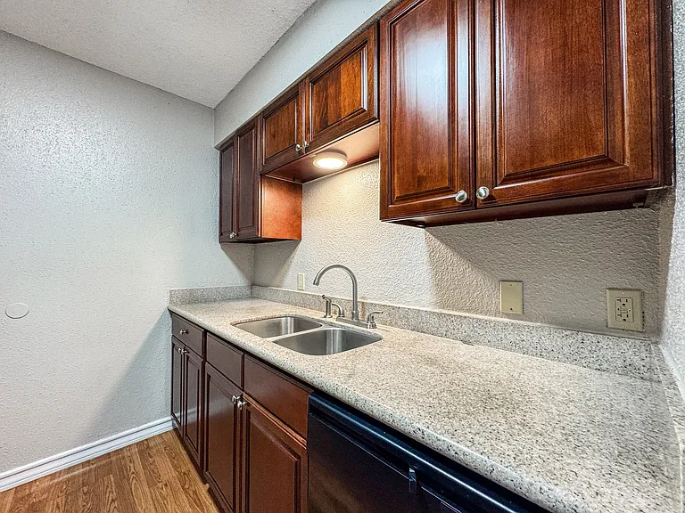 dark cabinetry in modern kitchen at Borders Apartments, Brownsville Texas.