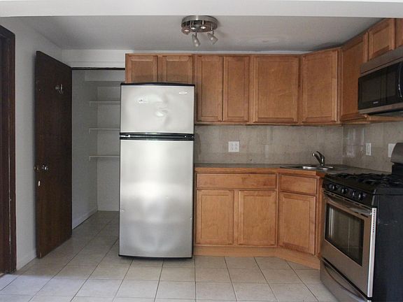 Cherry Cabinets - Good lighting, Deep Stainless and marble backsplash. Efficient