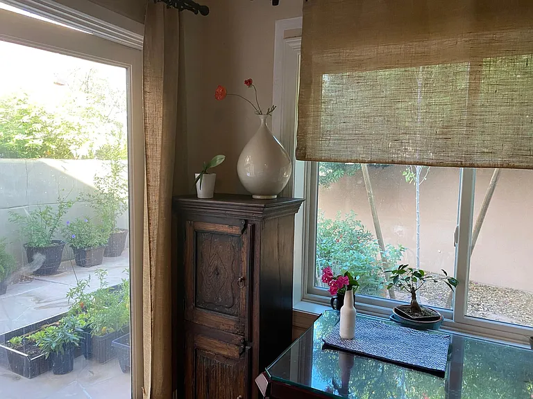 The other side of kitchen by the french door and window. You can hear bird chirping every morning and see a hummingbird sucking honey