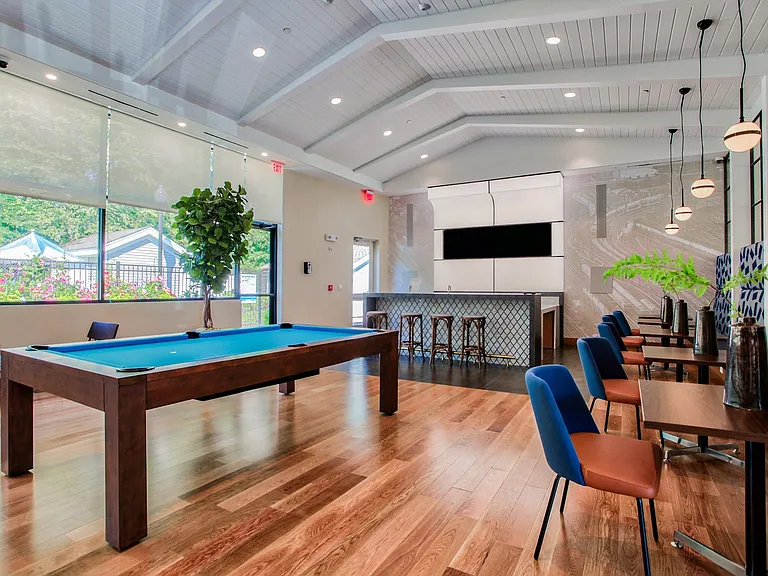The entertainment lounge is complete with two large screen TVs and bar seating