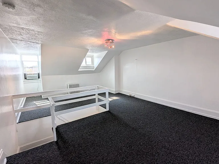 3rd Floor bedroom beaming with light/total of three windows with beautiful views of the city and rolling hills of Pittsburgh