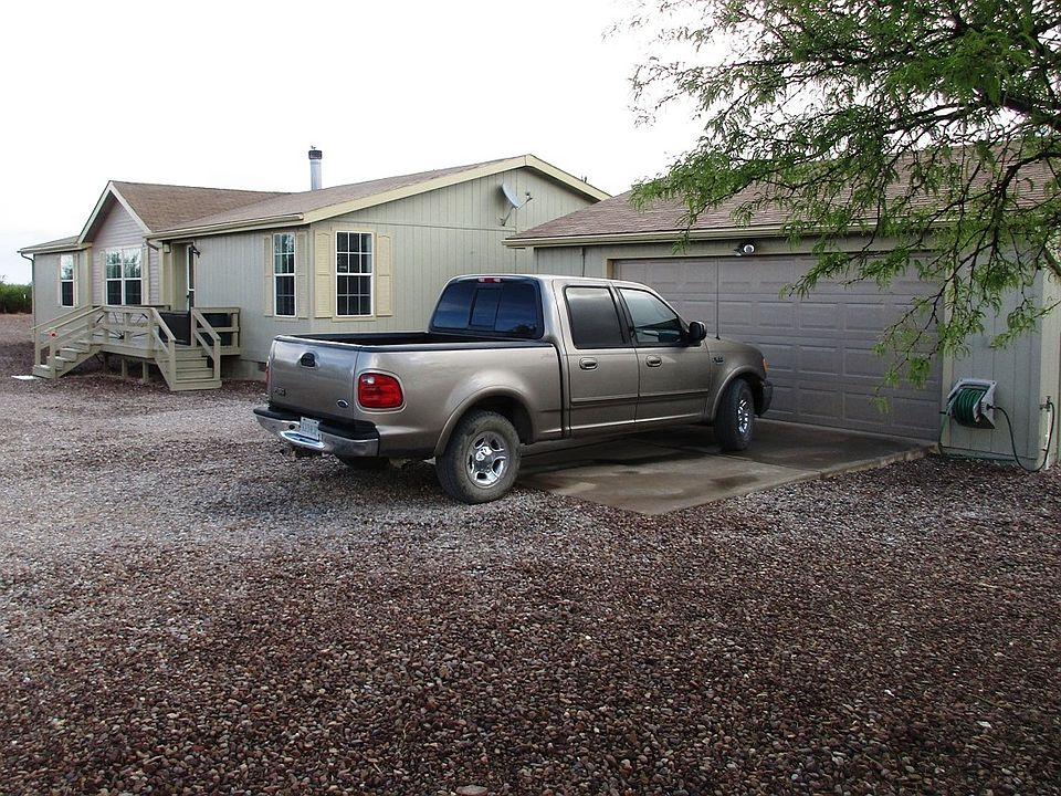 Home surrounded by gravel.