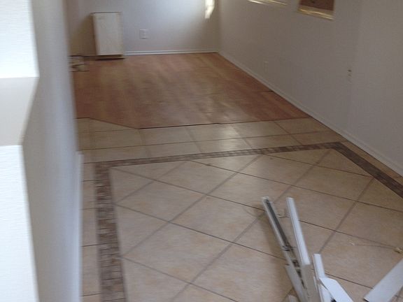 Hardwood flooring and ceramic tile in living areas.