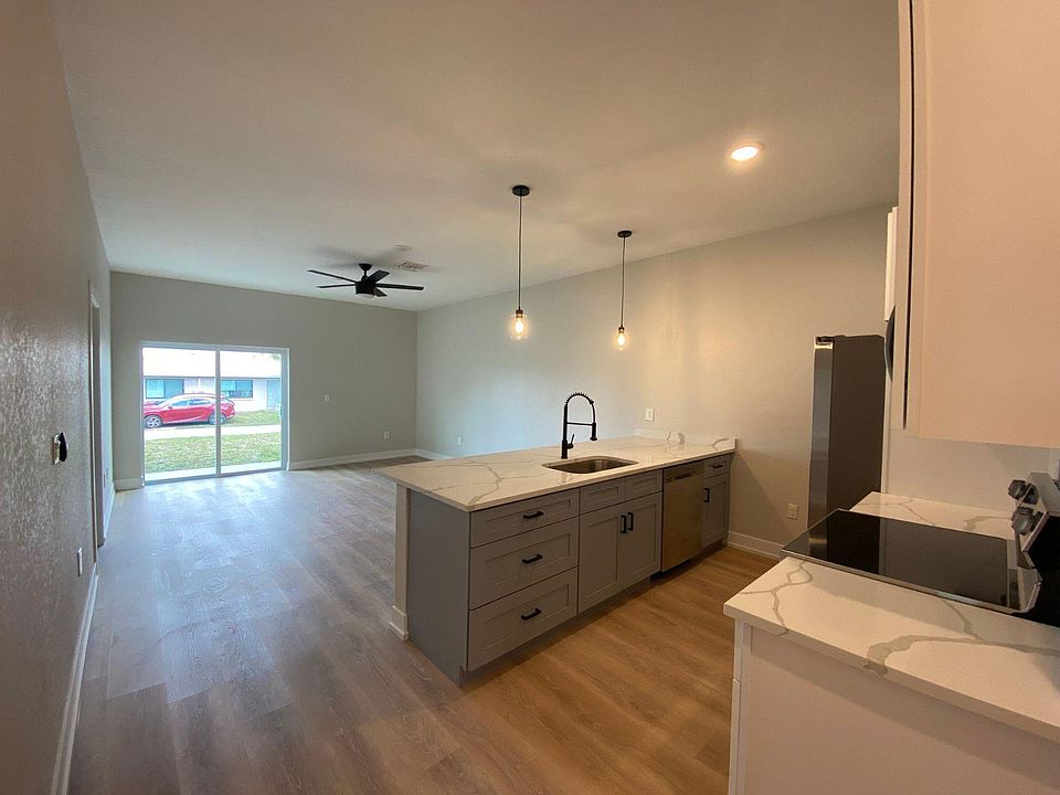 Open concept kitchen, dining, and living areas.