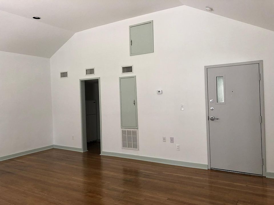 Vaulted ceiling & hardwoods in living room.