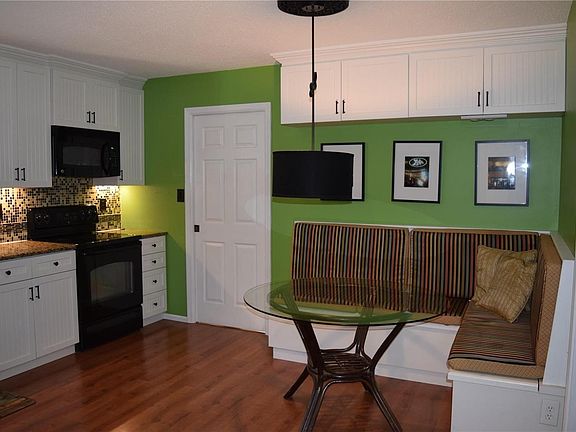 Beautifully updated kitchen with so much cabinet space, banquette seating with reversible cushions. Pocket door to the left leads to the laundry room, and then garage. Kitchen updated 2012