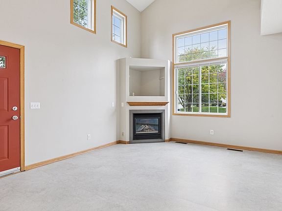 Living room, freshly painted and new flooring. Tall ceiling and light from multiple sides of the home