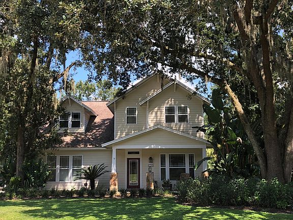 Mature trees and landscaping grace the large front yard
