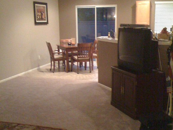 old photo of living room and dinning room. refer to video to see new flooring and wall color