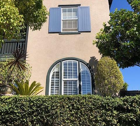 The front of our home, the arched window on the bottom floor is the studio.