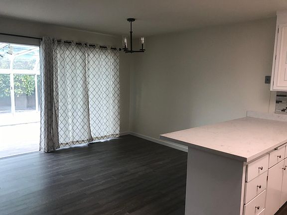 open concept with bar at kitchen. Dinning room that opens to Sun Room