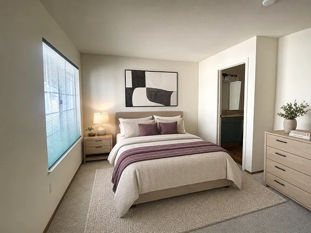 2nd bedroom junior suite with attached full bath. Staged for layout visualization; unit comes unfurnished"