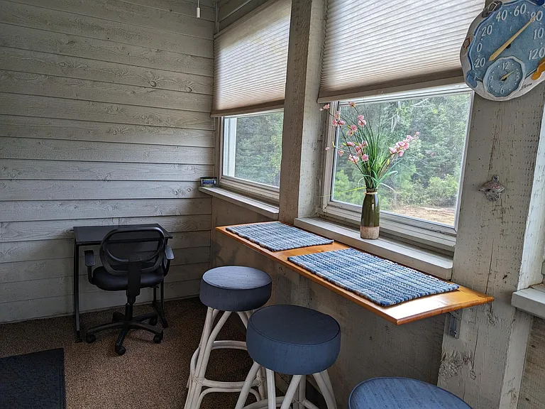 Enclosed balcony with work area.