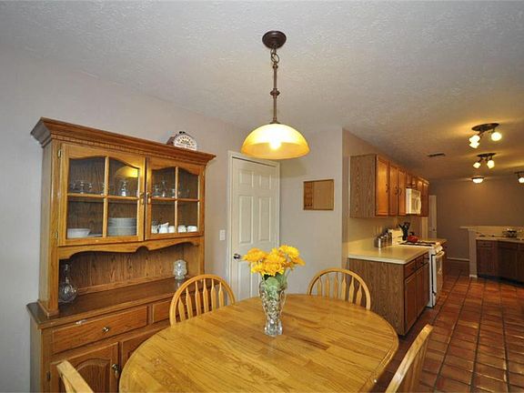  Large Breakfast nook is nestled through the galley kitchen near the garage, it is it the perfect hub for unloading groceries or for the kids to snack and work on homework!