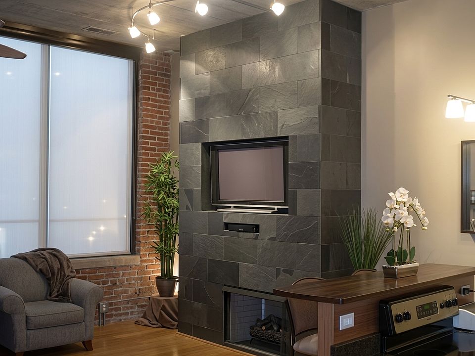 Living room with slate fireplace that has a custom TV area, can set a 47" TV in enclosure or mount up to 60".