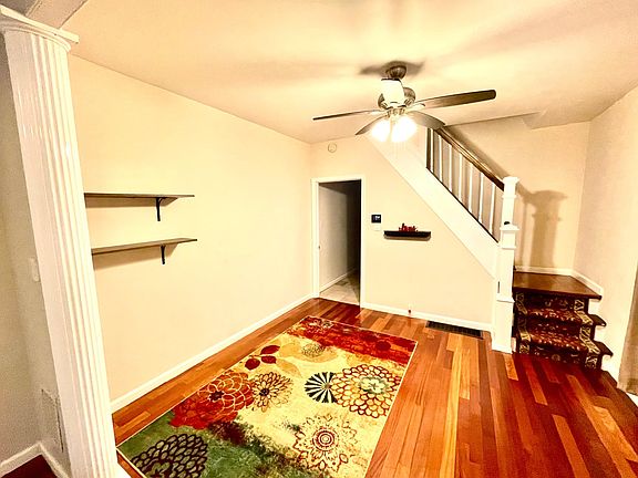 Photo of second room on first floor with hardwood flooring and lighting