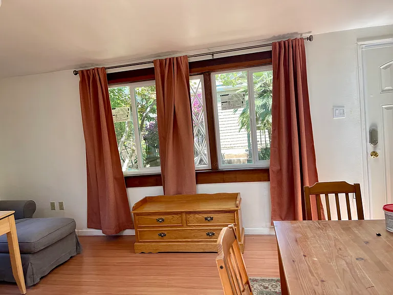 Dining/living area with desk, chair, couch and dining table set