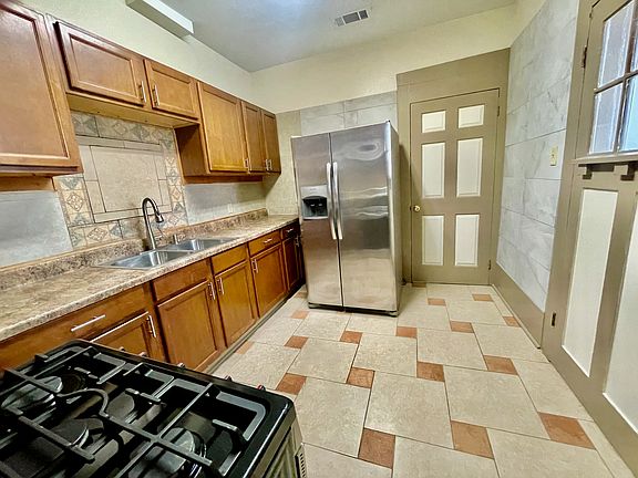 Kitchen comes with refrigerator with ice maker, gas range, and microwave. It also has a closet pantry and storage.