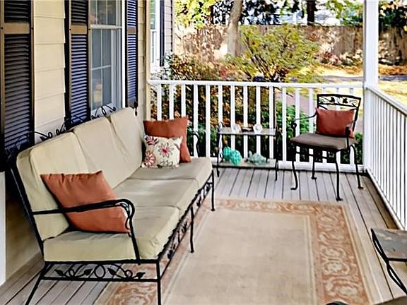 This is one side of the quiet front porch - room to entertain or enjoy morning coffee.