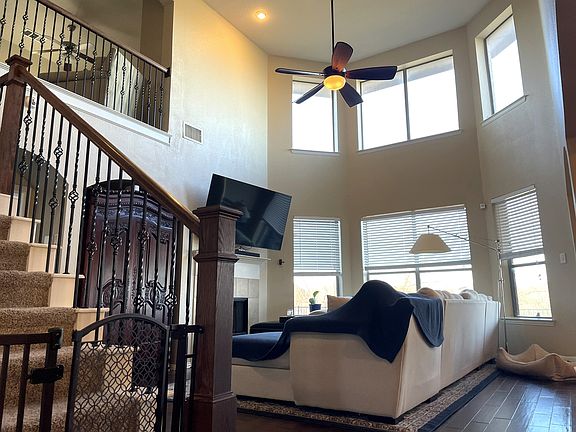 Dramatic two-story living room filled with natural light