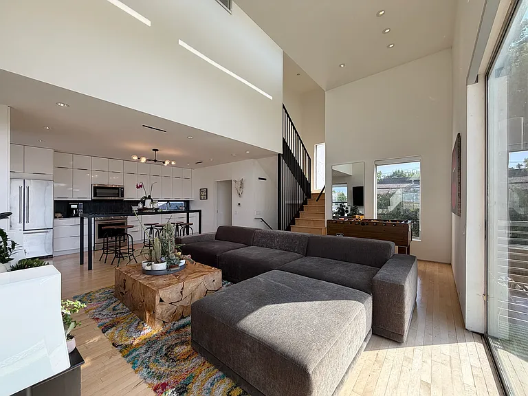 The living room leads to your outdoor balcony, looking out on all the restaurants and shopping on Henderson Ave.
