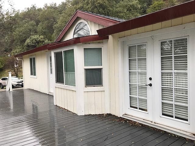 Front of house showing bay window, french door, skylight, and deck