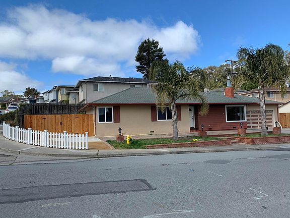 Corner single family home with side yard gate access.
