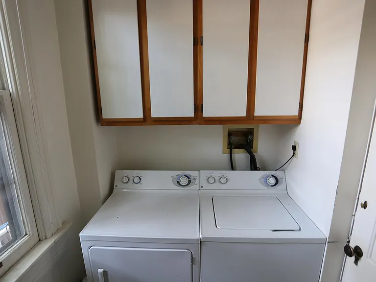 Washer and Dryer in half bath by kitchen.